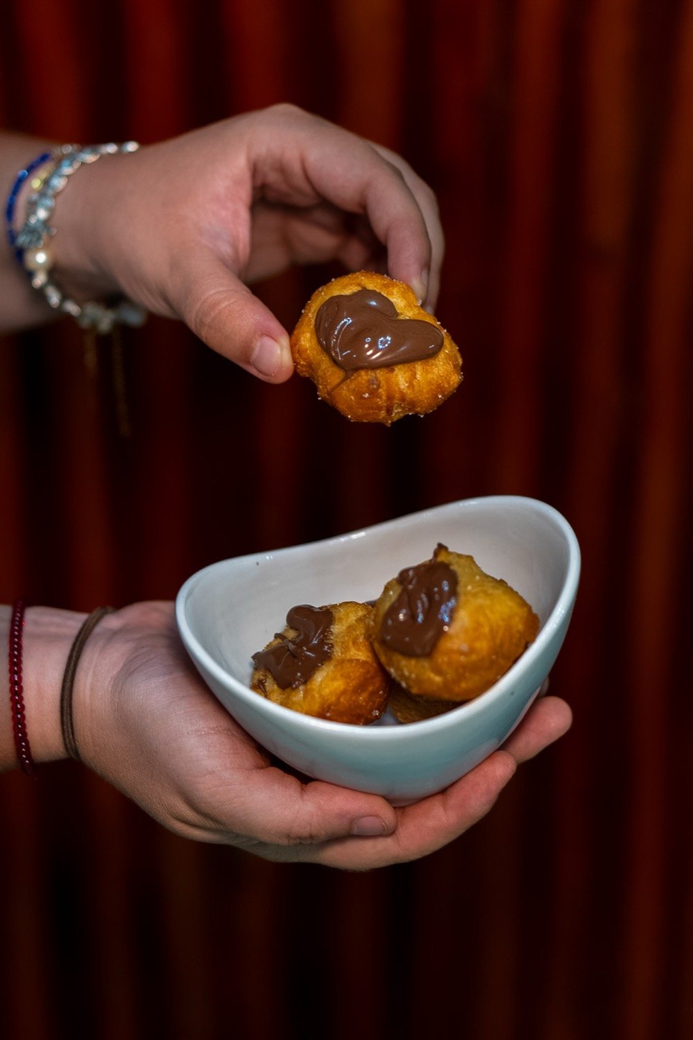 Dolci fritti con crema di cioccolato serviti in ciotola